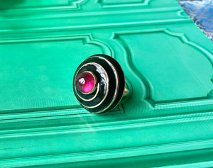 A Rubellite cabochon & black enamel ring