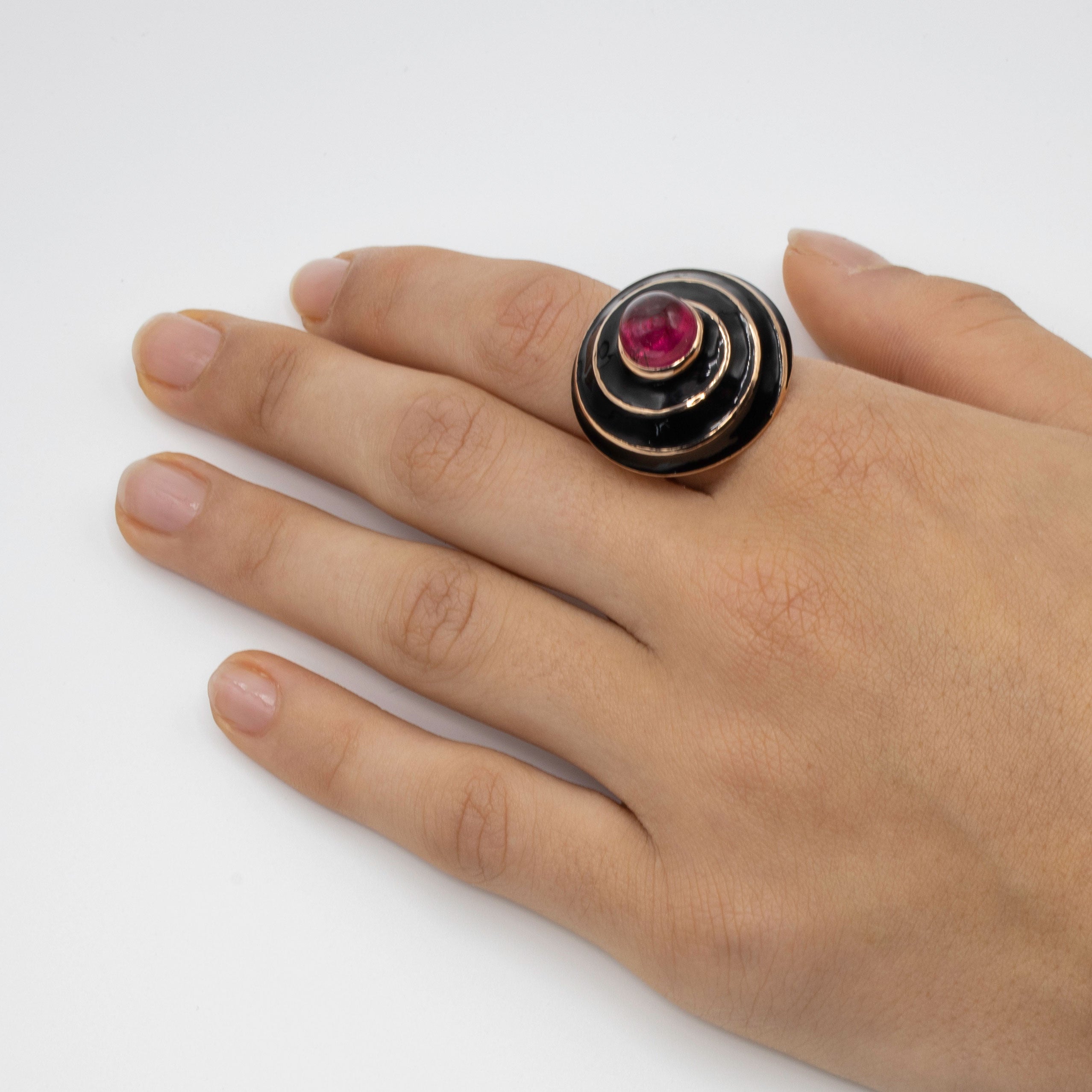 A Rubellite cabochon & black enamel ring